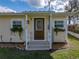 Charming home featuring a welcoming front entrance with decorative plants and a well-manicured lawn at 5418 Cooper Ln, Fort Meade, FL 33841