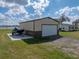 Spacious two-car garage with a boat parked outside, complementing the nearby house and waterside setting at 5418 Cooper Ln, Fort Meade, FL 33841