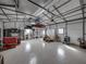 Spacious garage with an epoxy floor, multiple storage shelves and workspace for projects at 5418 Cooper Ln, Fort Meade, FL 33841