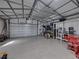Spacious garage with an epoxy floor, overhead door, and ample storage and work space at 5418 Cooper Ln, Fort Meade, FL 33841