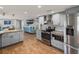 Spacious kitchen with stainless steel appliances, granite countertops, gray cabinets, and a seamless view into the living room at 5418 Cooper Ln, Fort Meade, FL 33841