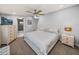 Serene main bedroom with a TV, ceiling fan, and a view into the en-suite bathroom at 5418 Cooper Ln, Fort Meade, FL 33841