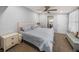 Relaxing main bedroom featuring neutral tones, a ceiling fan, and a glimpse into the adjoining bathroom at 5418 Cooper Ln, Fort Meade, FL 33841