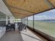 Inviting screened-in patio with plush seating arrangements overlooking a serene waterfront view at 5418 Cooper Ln, Fort Meade, FL 33841