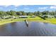 Beautiful waterfront with a long wooden dock extending into the lake and a well-maintained lawn at 5418 Cooper Ln, Fort Meade, FL 33841