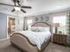 Comfortable bedroom with a ceiling fan, a decorative headboard, and soft, inviting bedding at 5443 Se 127Th Ln, Belleview, FL 34420