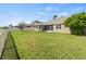 View of the grassy backyard with a fence on a sunny day at 5623 Superior Dr, Lakeland, FL 33805