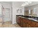 Bathroom featuring a double vanity, glass shower, and walk-in closet at 5623 Superior Dr, Lakeland, FL 33805