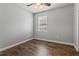 Bright bedroom featuring a ceiling fan, window, and wood-look flooring at 5623 Superior Dr, Lakeland, FL 33805