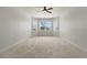 Bright, carpeted bedroom featuring neutral walls and a ceiling fan at 5623 Superior Dr, Lakeland, FL 33805