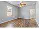 This bedroom features wood floors and a view of the walk-in closet at 5623 Superior Dr, Lakeland, FL 33805