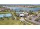 Aerial shot of the community clubhouse with a pool, playground, and tennis court near the lake at 5623 Superior Dr, Lakeland, FL 33805