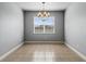 Dining room with modern chandelier, large window, and neutral color palette at 5623 Superior Dr, Lakeland, FL 33805