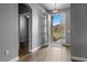 Open entryway with wood flooring, modern light fixture, and view to the home's front exterior at 5623 Superior Dr, Lakeland, FL 33805