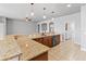 Kitchen area with granite countertops, stainless steel dishwasher, sink and pendant lighting at 5623 Superior Dr, Lakeland, FL 33805