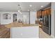 Kitchen view showcasing granite countertops, a center island, modern pendant lights, and stainless appliances at 5623 Superior Dr, Lakeland, FL 33805