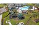 Aerial view of a community playground with multiple slides and picnic tables surrounded by lush greenery at 5623 Superior Dr, Lakeland, FL 33805