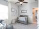 Cozy bedroom with a soft color palette, a crib, and a comfortable rocking chair at 567 Silver Course Radl, Ocala, FL 34472