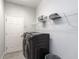 Functional laundry room featuring a washing machine, dryer, and shelving for storage at 567 Silver Course Radl, Ocala, FL 34472