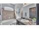 Bathroom featuring a tub with tile surround and dark marbled vanity at 5806 Valentino Way, Lakeland, FL 33812