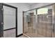 Glass-enclosed shower has tile surround and a built-in bench at 5806 Valentino Way, Lakeland, FL 33812