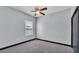 Bedroom has neutral walls, carpet, a ceiling fan, and a window at 5806 Valentino Way, Lakeland, FL 33812