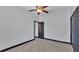 Bedroom featuring gray walls, dark trim, a ceiling fan and closet with doors at 5806 Valentino Way, Lakeland, FL 33812