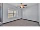 Bright carpeted bedroom with light walls and ceiling fan at 5806 Valentino Way, Lakeland, FL 33812