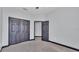 Bedroom featuring gray walls, dark trim, and a closet with bi-fold doors at 5806 Valentino Way, Lakeland, FL 33812