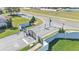 An aerial shot of a community's main entrance features a gate and manicured landscaping at 5806 Valentino Way, Lakeland, FL 33812