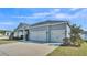 Spacious three-car garage offers ample parking and storage, complementing this home's appealing exterior at 5806 Valentino Way, Lakeland, FL 33812