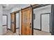 Hallway features sliding barn doors and leads to additional rooms in the home at 5806 Valentino Way, Lakeland, FL 33812