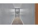 Narrow hallway features neutral walls and carpeted floor with a window at the end at 5806 Valentino Way, Lakeland, FL 33812