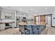 Kitchen featuring gray cabinets, island with bar seating, and tiled backsplash at 5806 Valentino Way, Lakeland, FL 33812