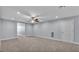 Large living room featuring gray walls, light carpet and a ceiling fan at 5806 Valentino Way, Lakeland, FL 33812