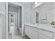 Bright bathroom featuring a vanity, mirror, and doorway leading to the outside at 6160 Broad Oak Dr, Davenport, FL 33837