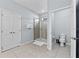 Bright bathroom featuring a glass door shower, a white toilet, and light blue walls at 6160 Broad Oak Dr, Davenport, FL 33837