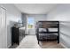 Functional bedroom featuring a bunk bed, dresser, and TV, illuminated by natural light from the window at 6160 Broad Oak Dr, Davenport, FL 33837