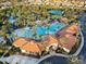 Resort-style pool area featuring palm trees, lounge chairs, and building with tile roof at 6160 Broad Oak Dr, Davenport, FL 33837