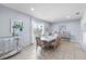 Bright dining room with a modern table, seating for six, and a view of the outdoors at 6160 Broad Oak Dr, Davenport, FL 33837