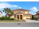 Two-story house featuring a clay tile roof, front lawn, and a two car garage at 6160 Broad Oak Dr, Davenport, FL 33837