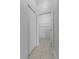 Hallway featuring a door, a doorway leading to a walk-in closet, and tile floor at 6160 Broad Oak Dr, Davenport, FL 33837