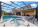 Beautiful screened-in pool area featuring a hot tub and plenty of seating for relaxation at 6160 Broad Oak Dr, Davenport, FL 33837