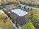 Aerial view of sand volleyball court, benches, and manicured landscaping at 6160 Broad Oak Dr, Davenport, FL 33837