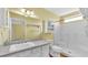 Bright bathroom with a large vanity, framed mirror, and walk-in shower with seats at 6193 Magpie Dr, Lakeland, FL 33809