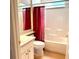 Bright bathroom with white tiling, a shower and tub combination, and a modern single sink vanity at 6193 Magpie Dr, Lakeland, FL 33809