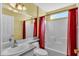 Well-lit bathroom with neutral colors and a shower-tub combination, a sink, and a toilet at 6193 Magpie Dr, Lakeland, FL 33809