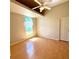 This bedroom features a ceiling fan, a window and light-colored walls and flooring at 6193 Magpie Dr, Lakeland, FL 33809