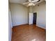 This bedroom features a ceiling fan, light-colored walls and flooring, and closet doors at 6193 Magpie Dr, Lakeland, FL 33809