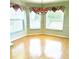 Sunlit breakfast nook with bright windows and wood-look floors next to the Kitchen at 6193 Magpie Dr, Lakeland, FL 33809